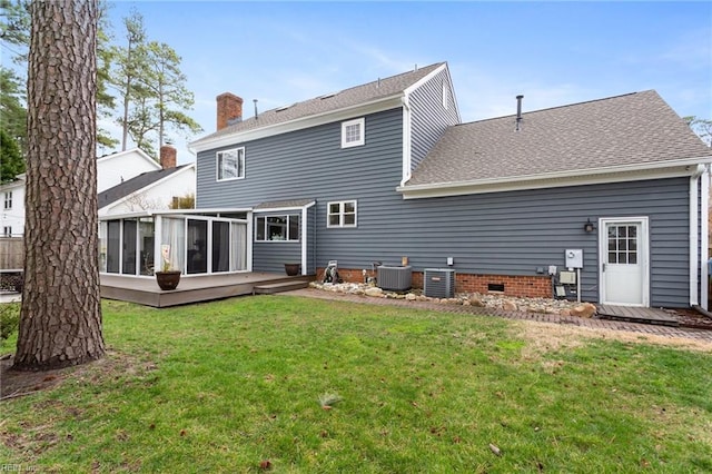 rear view of property with a chimney, a lawn, central AC unit, a sunroom, and crawl space