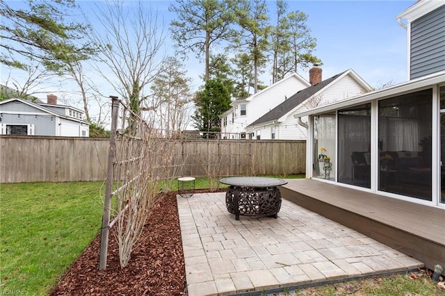 view of patio with a sunroom and fence