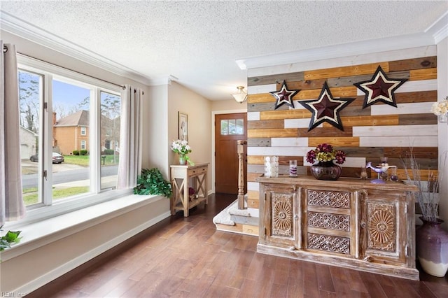 interior space with a healthy amount of sunlight, a textured ceiling, baseboards, and wood finished floors