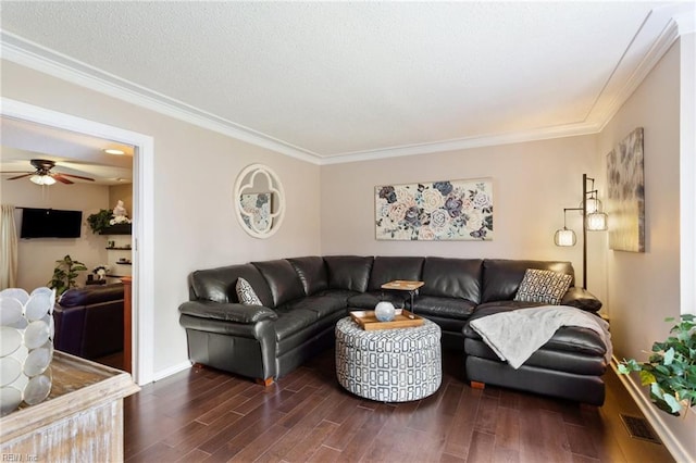 living room featuring a textured ceiling, wood finished floors, a ceiling fan, baseboards, and crown molding