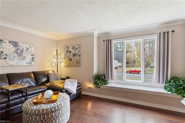 living area featuring baseboards, visible vents, ornamental molding, wood finished floors, and a textured ceiling