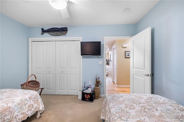 bedroom featuring a closet, light carpet, and ceiling fan