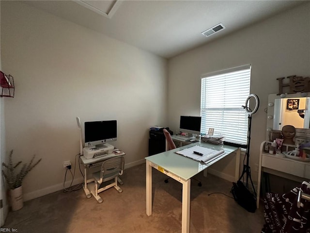 carpeted office space featuring visible vents and baseboards