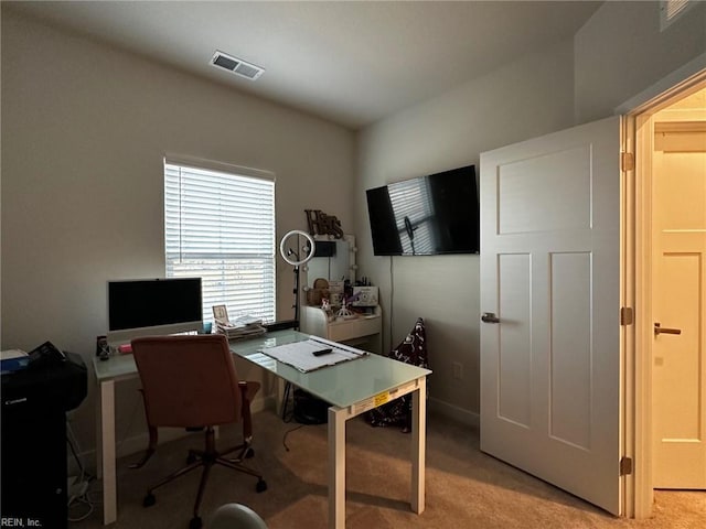 office area featuring light carpet and visible vents