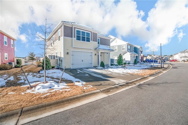 view of property featuring an attached garage, driveway, and a residential view