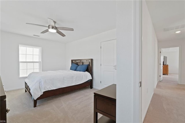 bedroom featuring light carpet, baseboards, and visible vents