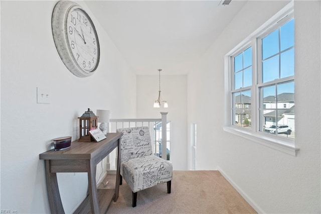 living area featuring carpet floors and baseboards