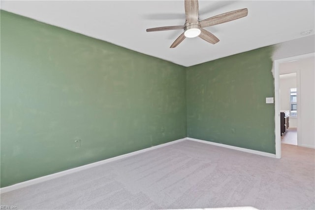 empty room with carpet, baseboards, and ceiling fan