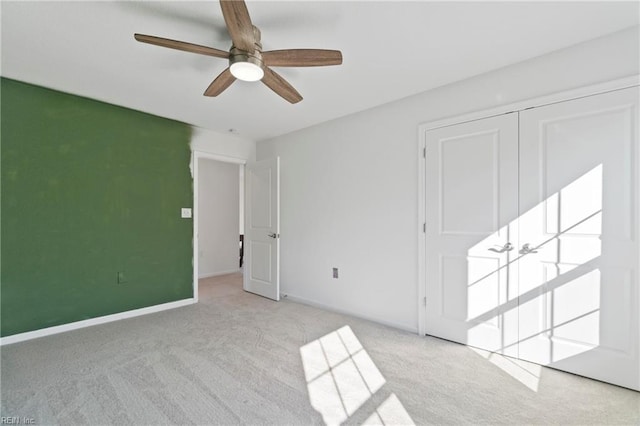 unfurnished bedroom with carpet, baseboards, and a ceiling fan