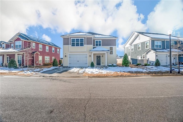 townhome / multi-family property featuring a garage, a residential view, and concrete driveway