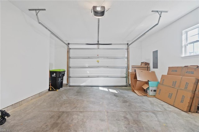 garage with a garage door opener and electric panel