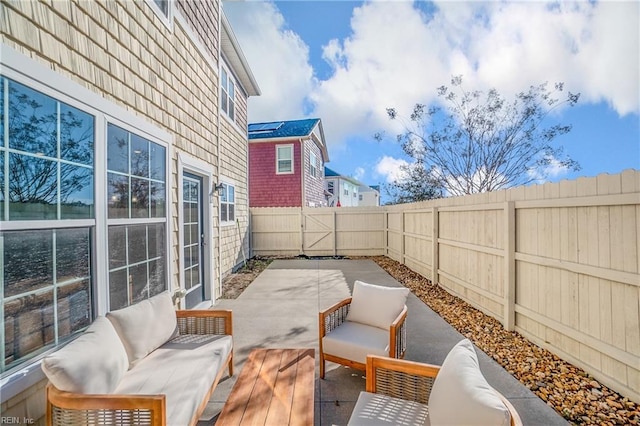 view of patio featuring an outdoor hangout area and a fenced backyard