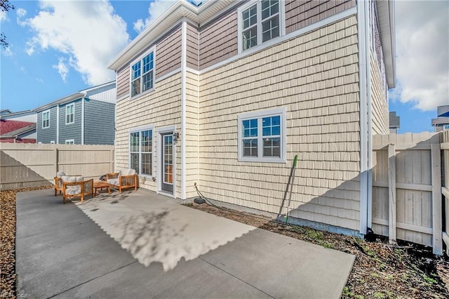 rear view of house featuring a patio and a fenced backyard