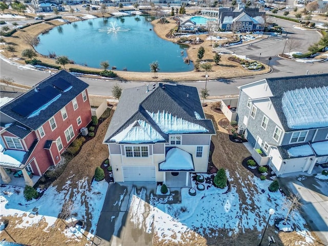 drone / aerial view featuring a water view and a residential view