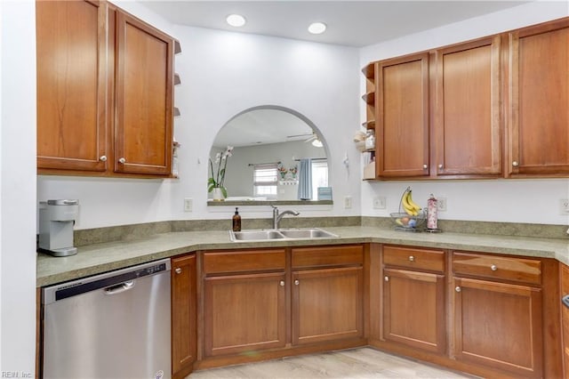 kitchen with arched walkways, a sink, stainless steel dishwasher, and open shelves