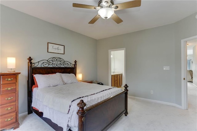 bedroom featuring light carpet, ceiling fan, connected bathroom, and baseboards