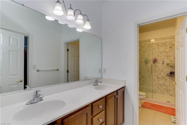 bathroom featuring double vanity, a stall shower, tile patterned flooring, and a sink