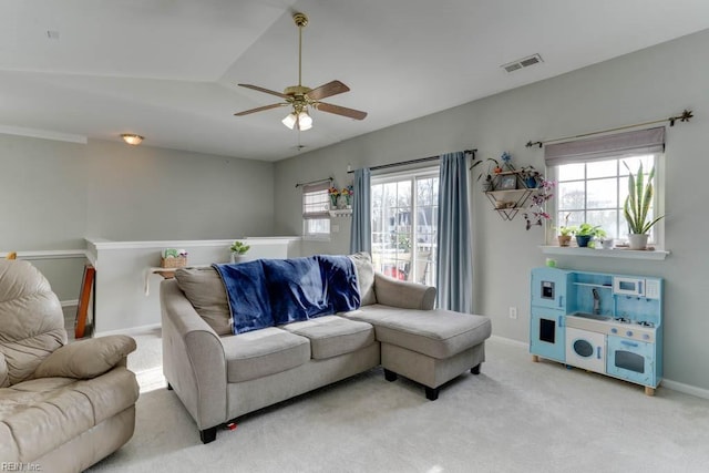 living room featuring carpet floors, plenty of natural light, baseboards, and ceiling fan