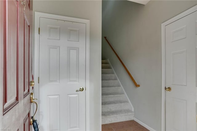 staircase with tile patterned flooring and baseboards