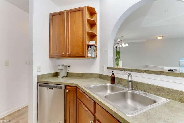 kitchen with brown cabinets, a sink, stainless steel dishwasher, and open shelves