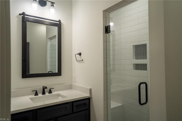 bathroom featuring a shower stall and vanity