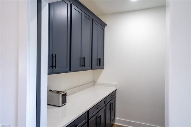 interior space featuring light countertops and baseboards