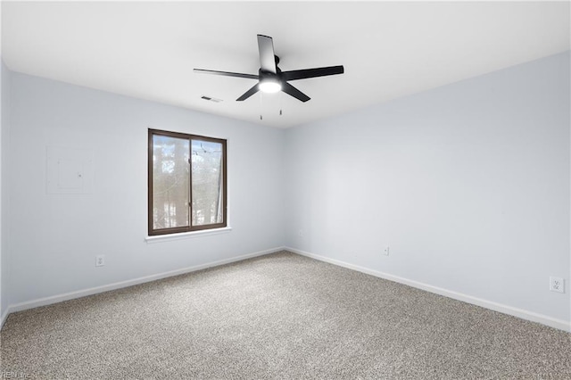 carpeted empty room featuring ceiling fan, visible vents, and baseboards