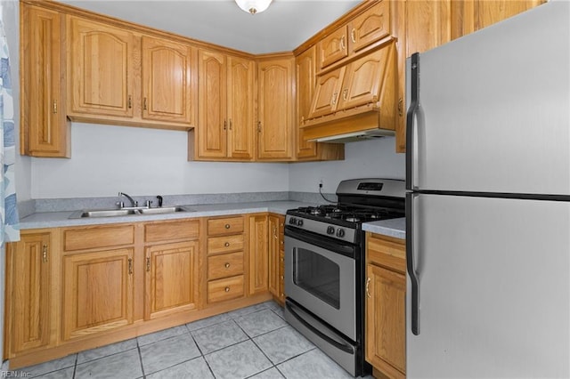 kitchen with light tile patterned floors, appliances with stainless steel finishes, light countertops, premium range hood, and a sink