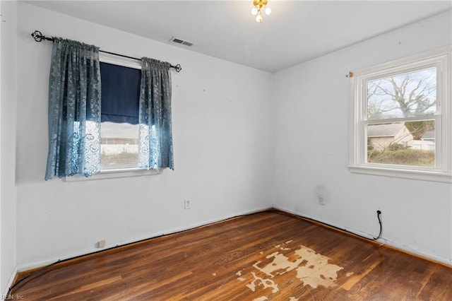 spare room with visible vents and wood finished floors