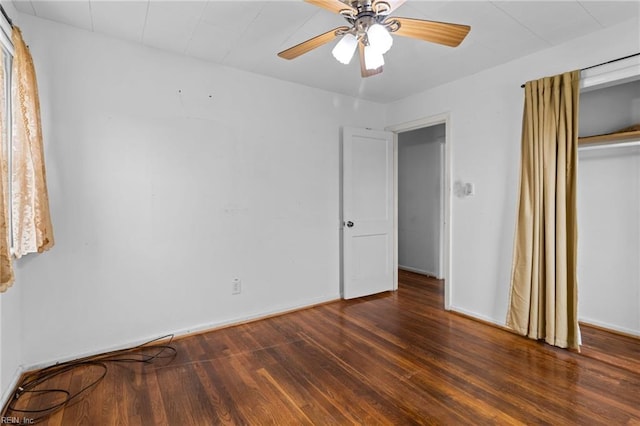 unfurnished bedroom featuring ceiling fan, a closet, wood finished floors, and baseboards