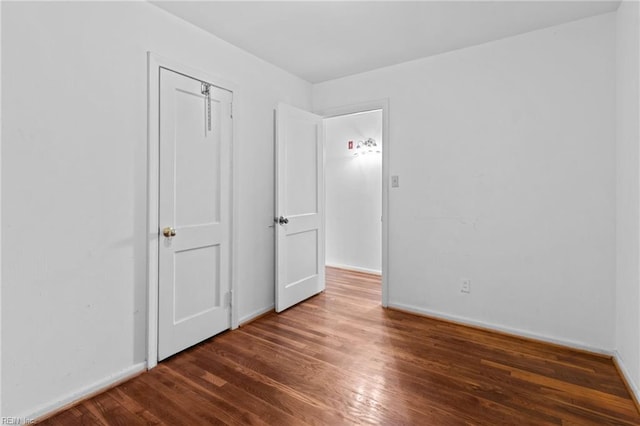 interior space with baseboards and wood finished floors