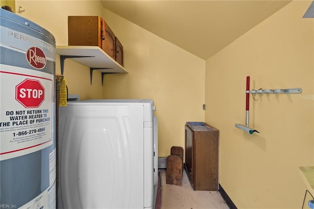 clothes washing area with laundry area, baseboards, and washer / clothes dryer