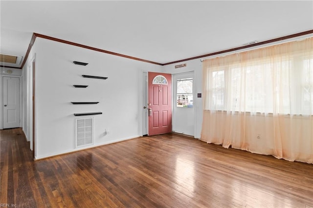 foyer entrance featuring wood finished floors, visible vents, and crown molding