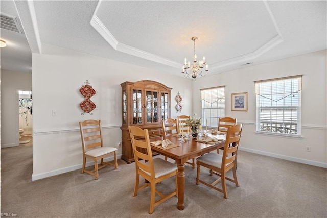 dining area featuring light carpet, baseboards, visible vents, a raised ceiling, and a textured ceiling