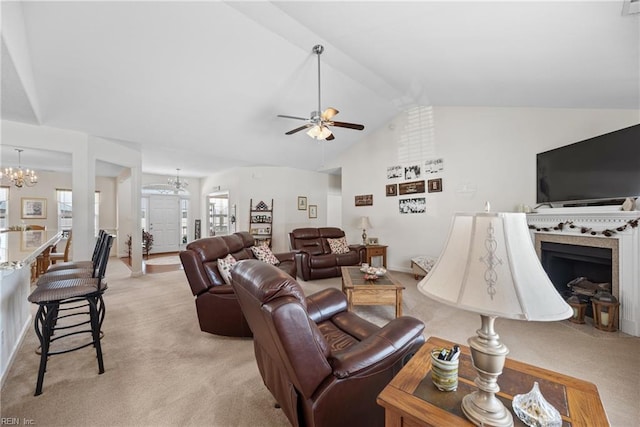 living area with light carpet, vaulted ceiling, and ceiling fan with notable chandelier