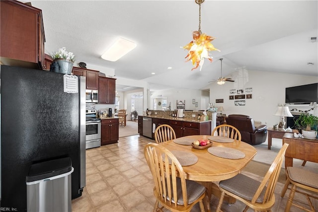 dining space featuring a ceiling fan, lofted ceiling, and light floors