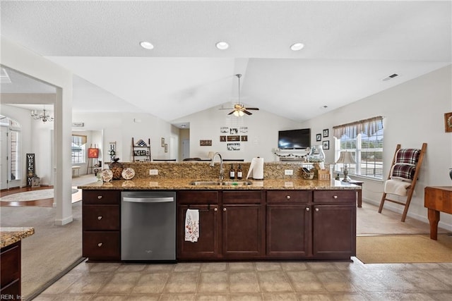 kitchen with lofted ceiling, a sink, visible vents, open floor plan, and dishwasher