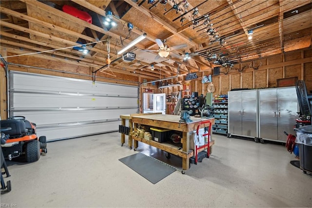 garage with a workshop area and a garage door opener