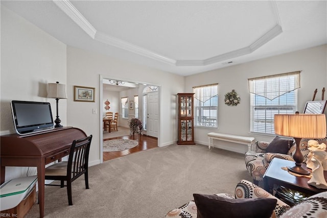 living room featuring a tray ceiling, baseboards, crown molding, and carpet