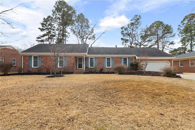 ranch-style home with a front lawn, crawl space, brick siding, and an attached garage