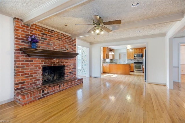 unfurnished living room with ornamental molding, light wood-type flooring, beam ceiling, and a textured ceiling