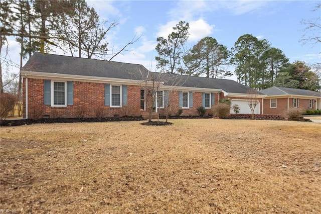 ranch-style house with crawl space, a garage, and brick siding