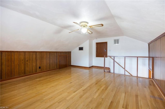 bonus room featuring vaulted ceiling, visible vents, and light wood-style floors