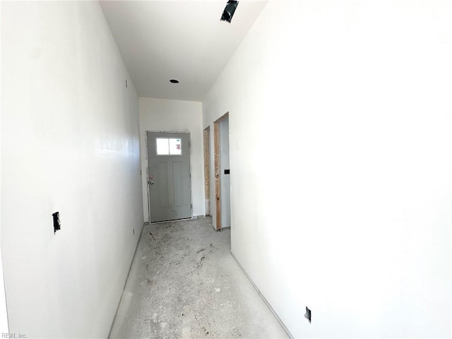 corridor with unfinished concrete floors