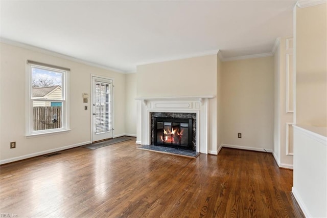 unfurnished living room with crown molding, baseboards, wood finished floors, and a high end fireplace