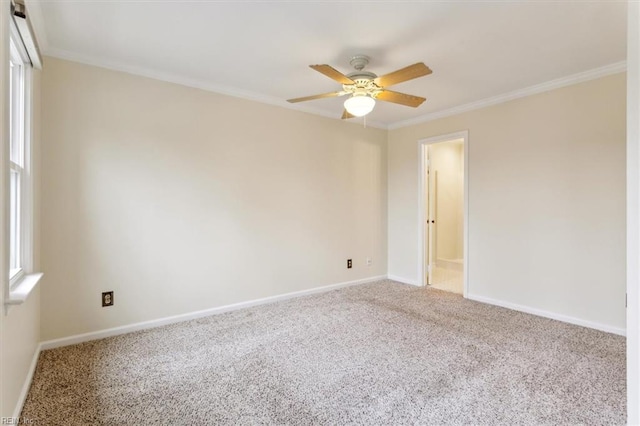 carpeted empty room with ornamental molding, ceiling fan, and baseboards