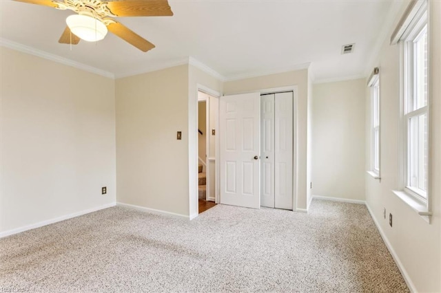 unfurnished bedroom with carpet, baseboards, and crown molding