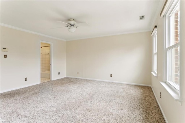 carpeted empty room with baseboards, visible vents, ceiling fan, and ornamental molding