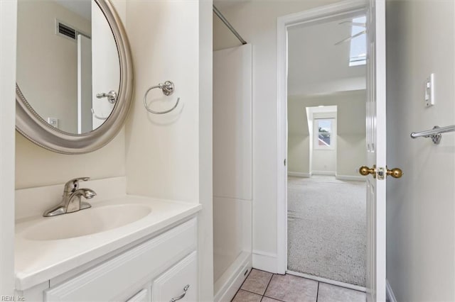 bathroom featuring a shower, visible vents, vanity, and tile patterned floors