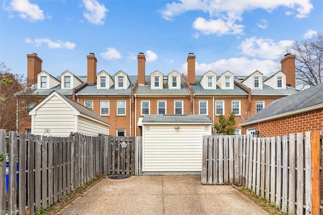 rear view of property featuring a patio area, a shed, an outdoor structure, and a fenced backyard